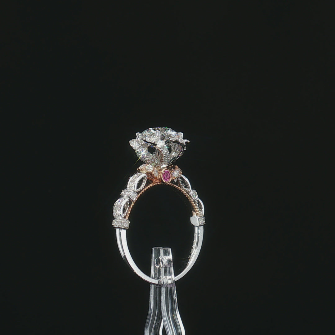 Rear gallery view of the floral halo ring with openwork shoulders and a rose-tone accent stone
